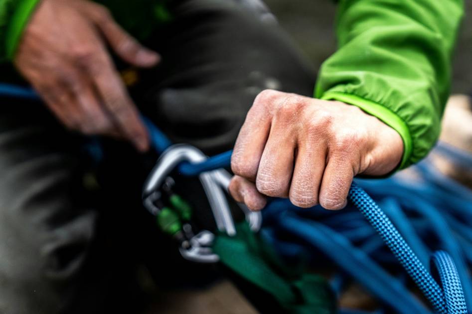Climber checking protection pieces on harness