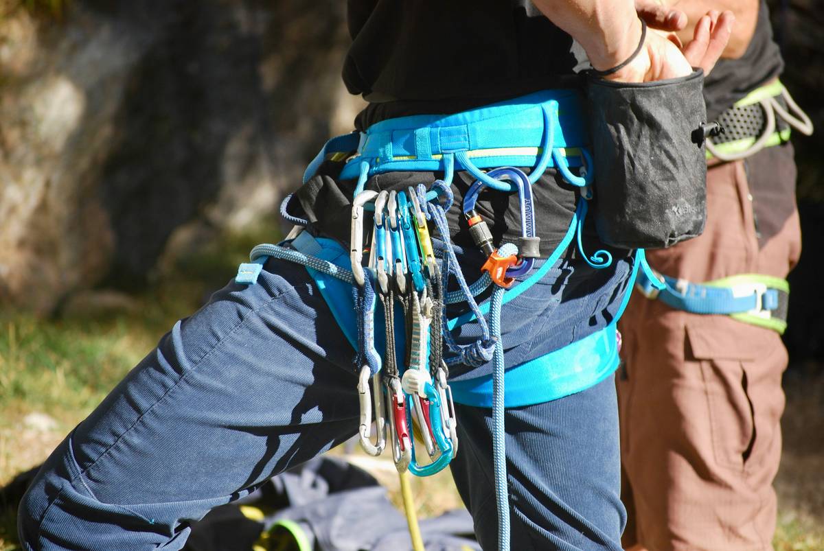 Close-up of route guard installation showing rope path and carabiner orientation