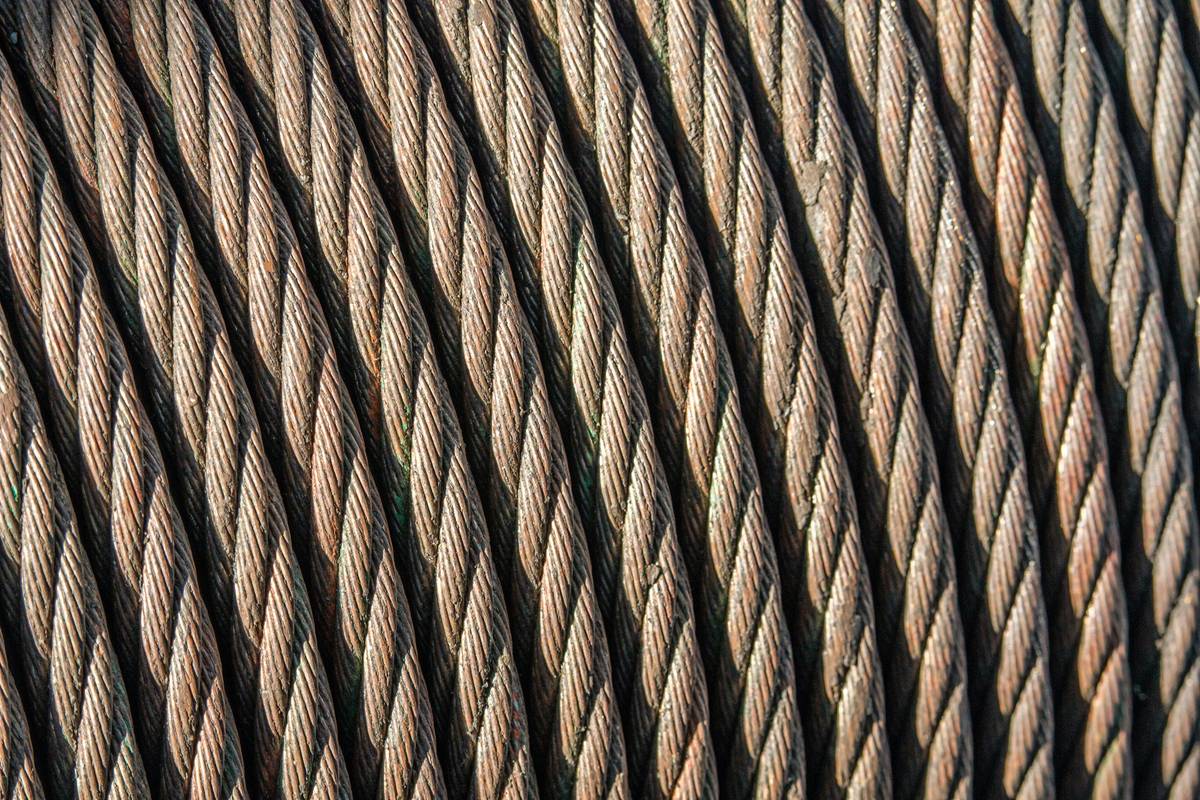 Close-up of worn climbing safety gear review showing frayed sling and corroded carabiner