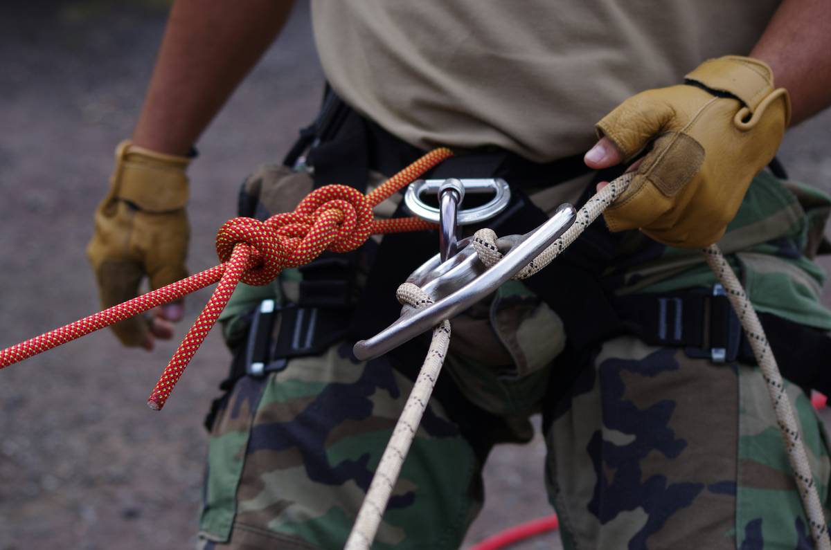 Close-up of climbing cam with route guard features highlighted on rock surface
