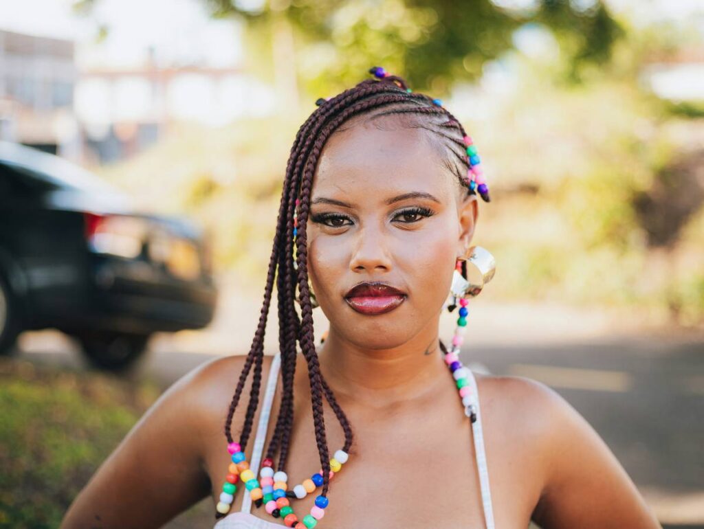 Young woman with braided hair and colorful beads